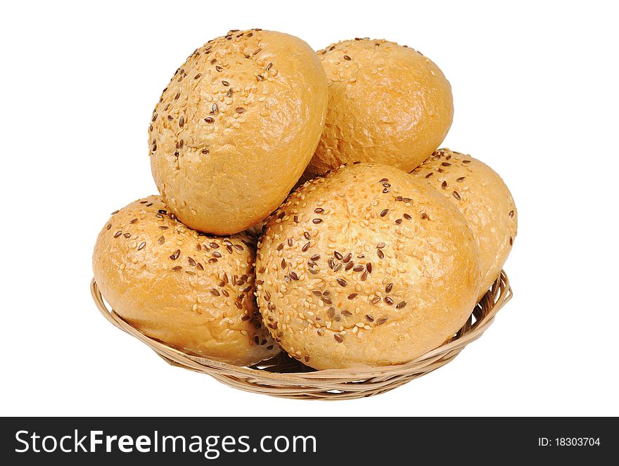 Bun, topped with sesame seeds in a basket. Isolated on white.