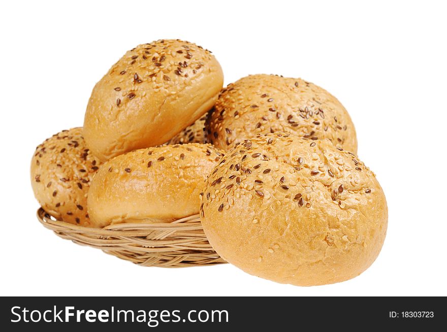 Bun, topped with sesame seeds in a basket. Isolated on white.