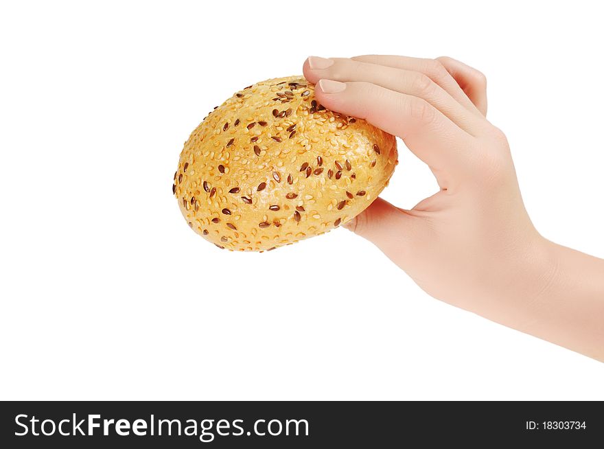 Bun, topped with sesame seeds in hand. Isolated on white.