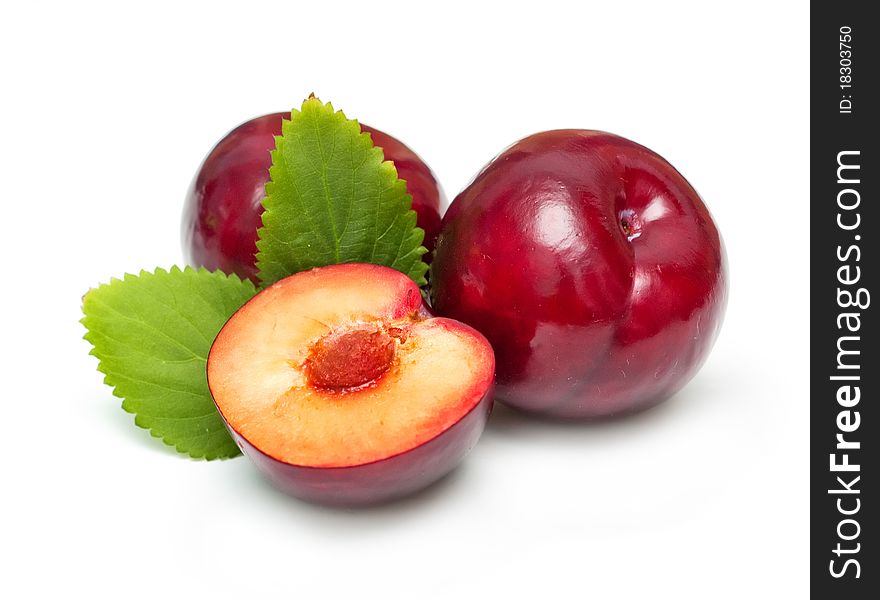 Ripe bright plums closeup on white background. Ripe bright plums closeup on white background