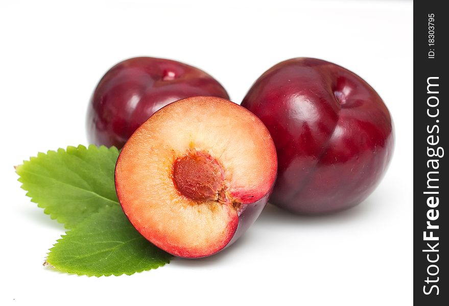 Ripe bright plums closeup on white background. Ripe bright plums closeup on white background