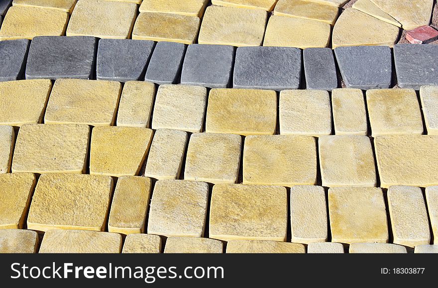 Terrace of yellow and red stone paved in rows