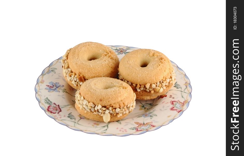 Three round cookies with nuts on a white background