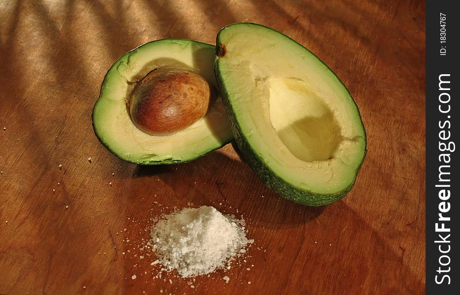 Avocado and salt on a wooden table