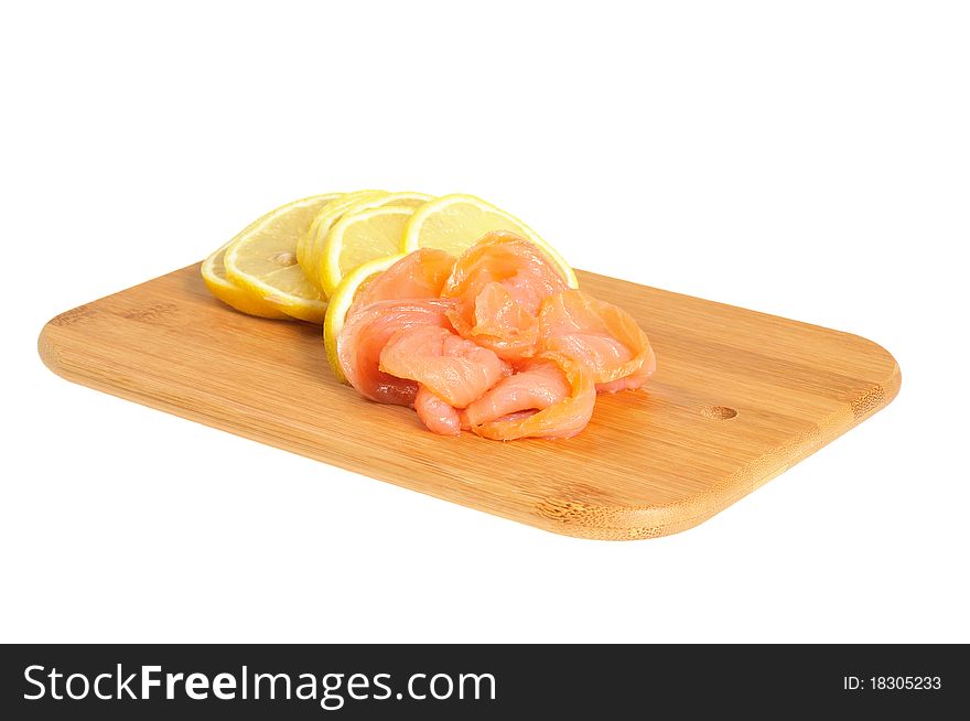 Salmon and lemon on wooden board. Isolated on white. Salmon and lemon on wooden board. Isolated on white
