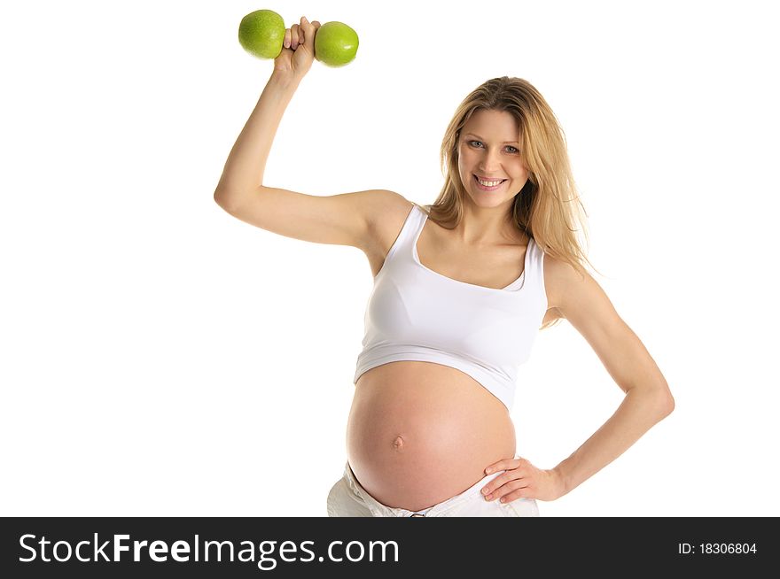 Pregnant woman involved in fitness dumbbells from apples