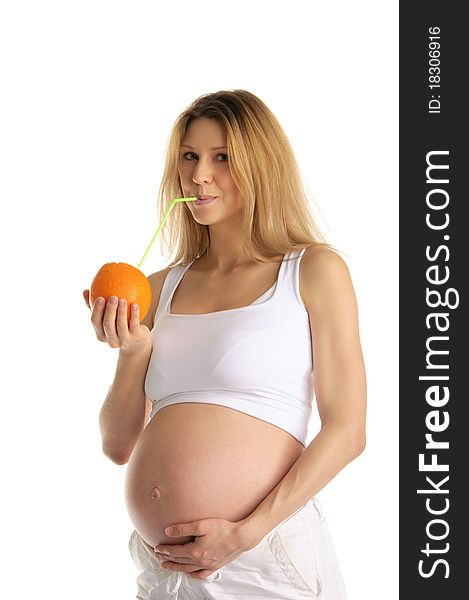 Pregnant woman drinking juice from the orange isolated on white