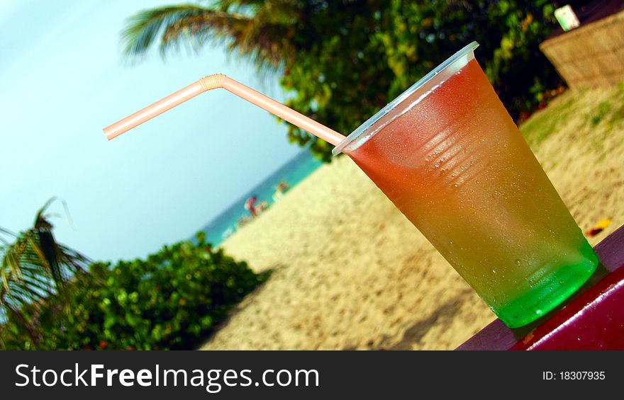 Cocktail Drink sitting on bench at beach