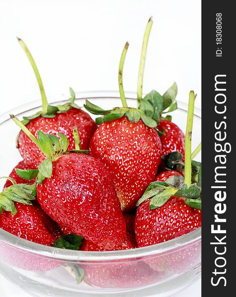 Red strawberry in a bowl isolated on white background