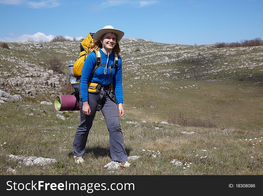 Girl in blue jacket with yellow backpack