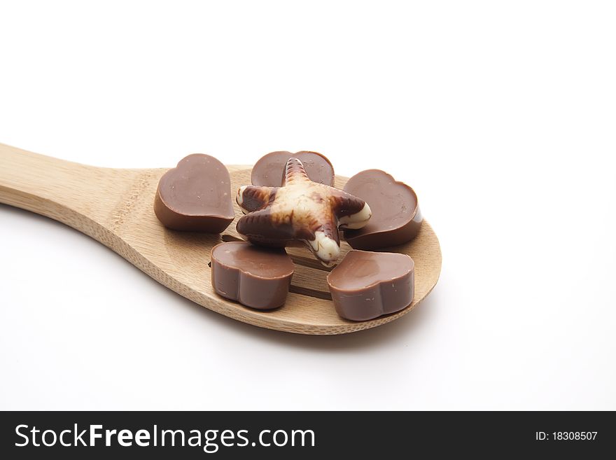 Chocolates with heart onto cook spoons