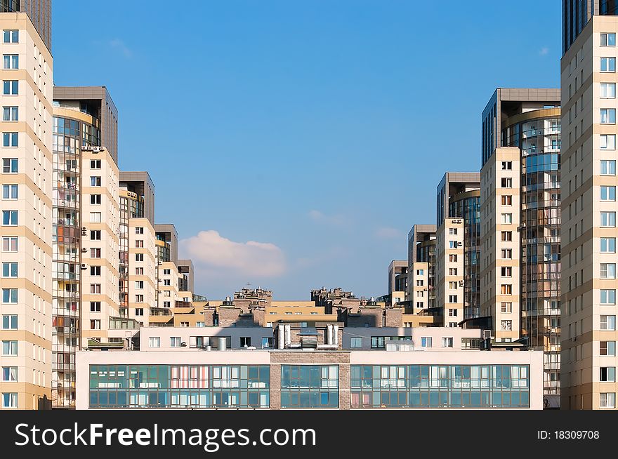 Dwelling houses constructed cascade on the blue sky background