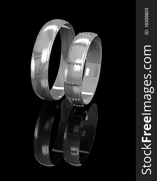 Wedding rings with brilliants on a black background