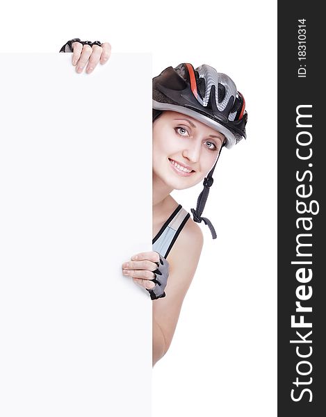 Pretty woman cyclist in a helmet holding a blank sign in front of her. Pretty woman cyclist in a helmet holding a blank sign in front of her