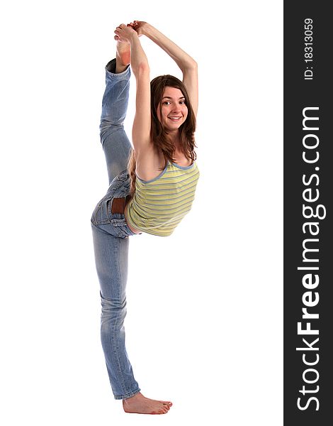 Girl in green stripy top takes leg up. Isolated on white.