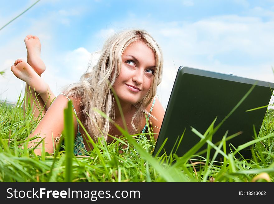 Beautiful girl on the meadow with notebook. Beautiful girl on the meadow with notebook