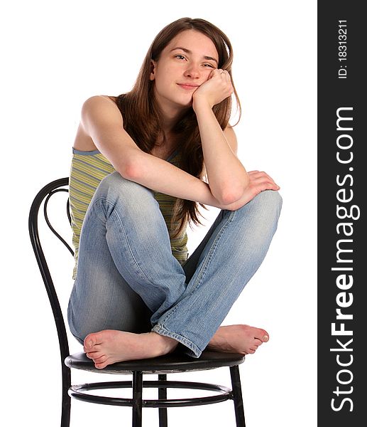 Girl in green stripy top sit on stool dreaming. Isolated on white.