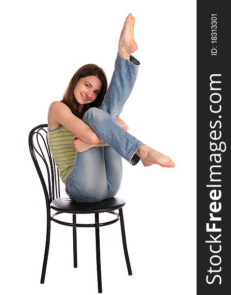 Girl in green stripy top sit on stool tuck up legs. Isolated on white. Girl in green stripy top sit on stool tuck up legs. Isolated on white.