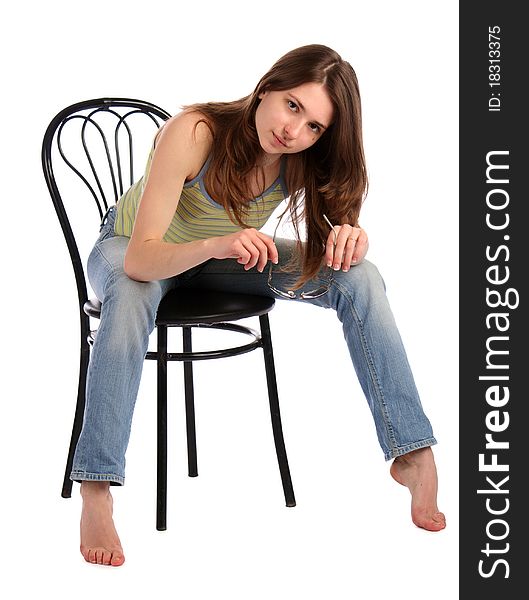 Girl in green stripy top sit on stool bend forward. Isolated on white. Girl in green stripy top sit on stool bend forward. Isolated on white.