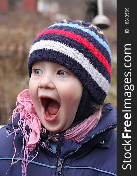 Portrait of the little boy, with widely open mouth which shouts.