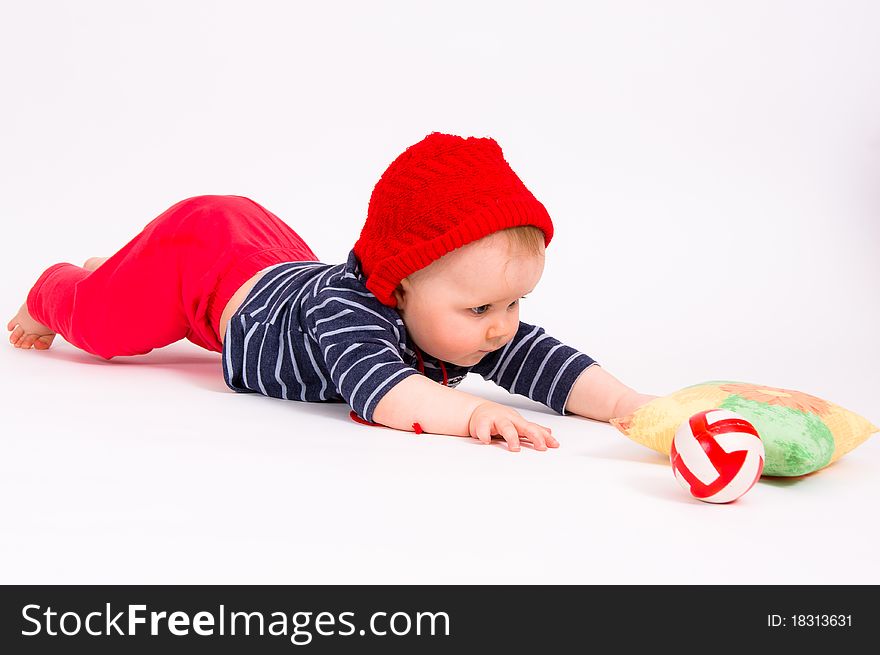 Little child baby crawling for the red ball