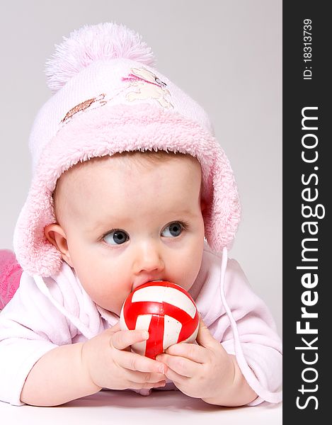 Little child baby with red ball