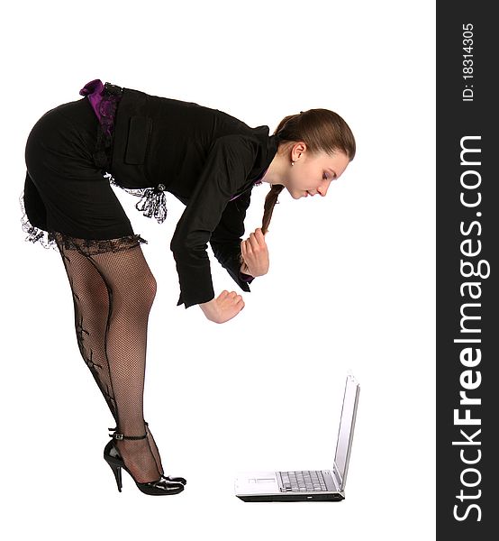 Girl in black suit bends to notebook.