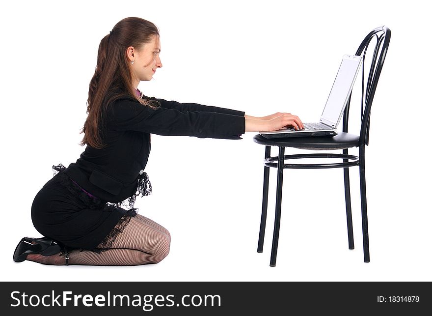 Girl in black suit sits on floor and works with notebook on stool. Isolated on white. Girl in black suit sits on floor and works with notebook on stool. Isolated on white.