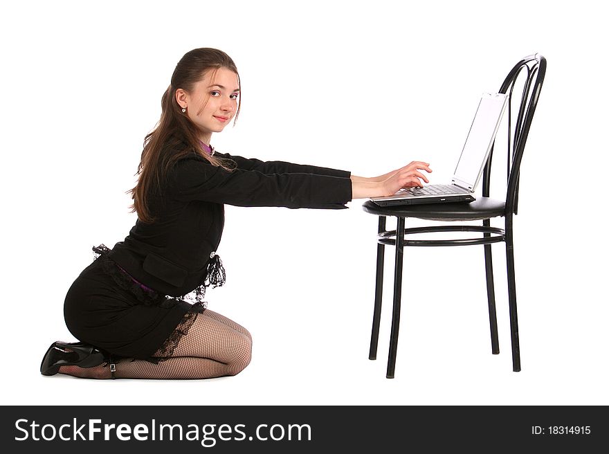 Girl sits on floor and works with notebook on stoo