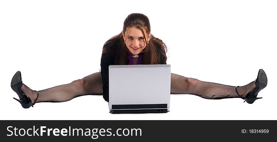 Girl makes splits with notebook on floor.