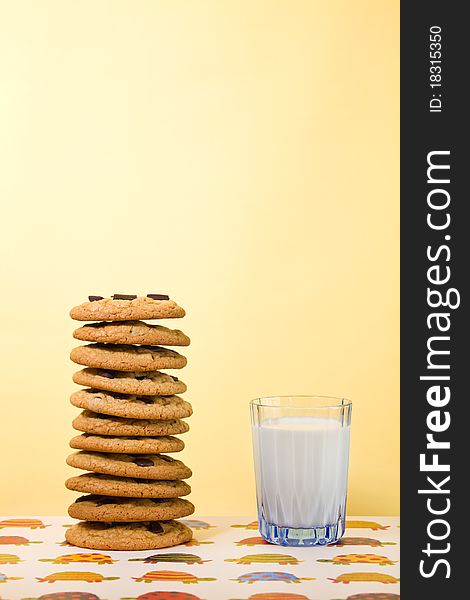 Butter cookie stacked with chocolate chip and milk on the side. Empty space to add your text. Very Shallow depth of field. Butter cookie stacked with chocolate chip and milk on the side. Empty space to add your text. Very Shallow depth of field.