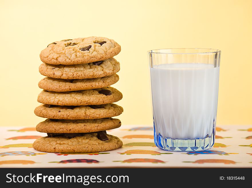 Butter cookie stacked with chocolate chip and milk on the side. Very shallow depth of field. Butter cookie stacked with chocolate chip and milk on the side. Very shallow depth of field.