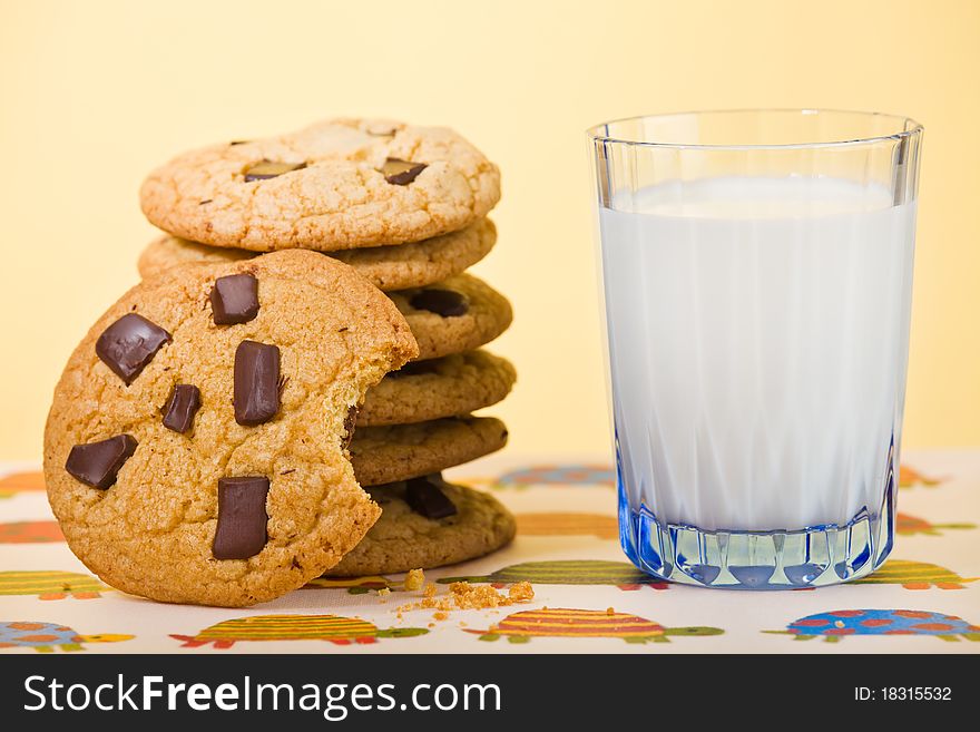 Butter cookie stacked with chocolate chip and milk on the side. Very shallow depth of field. Butter cookie stacked with chocolate chip and milk on the side. Very shallow depth of field.