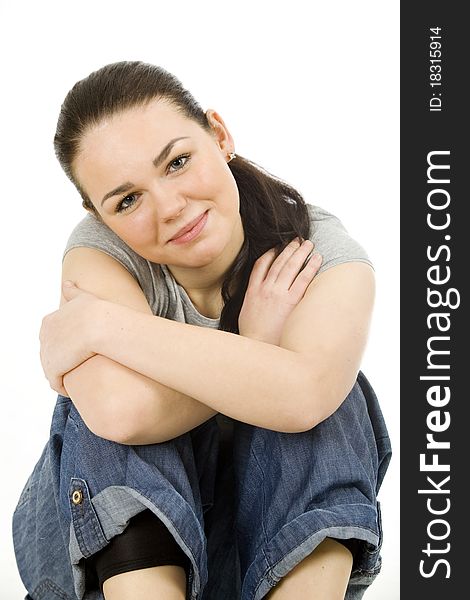 Pretty young woman sitting on the floor , smiling