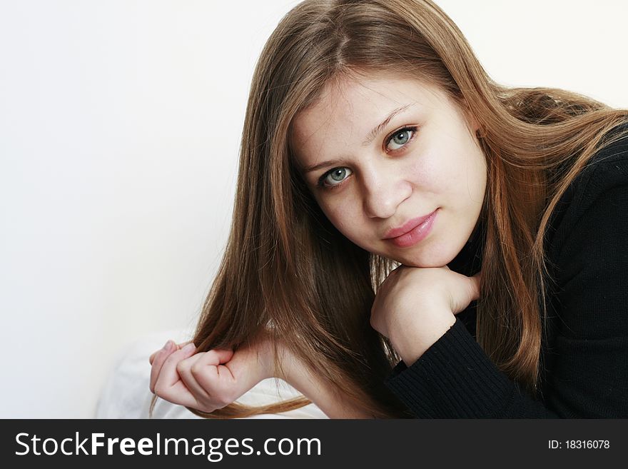 Beautiful young woman with her hand in the hair looking at the camera isolated on white background. Beautiful young woman with her hand in the hair looking at the camera isolated on white background