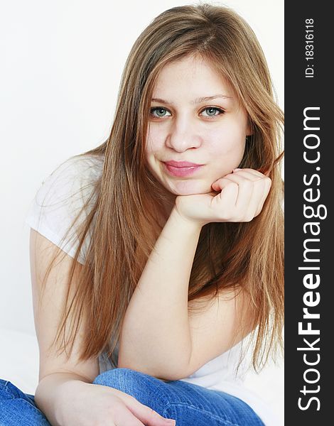 Beautiful young woman with a funny expression on her face looking at the camera isolated on white background. Beautiful young woman with a funny expression on her face looking at the camera isolated on white background