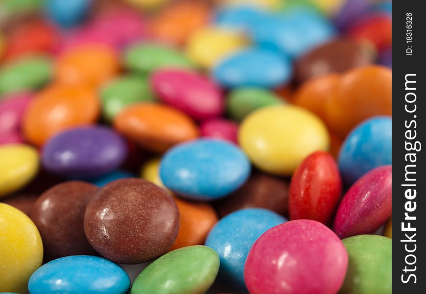 A close-up of many coloured chocolate drops