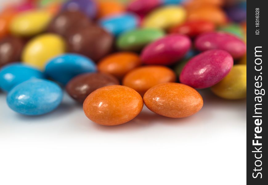 A close-up of many coloured chocolate drops