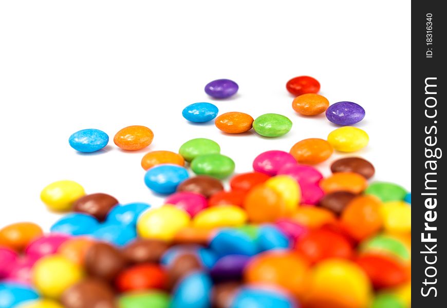 A close-up of many coloured chocolate drops