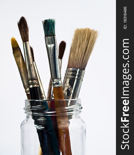 Paintbrushes in a Glass isolated on white background