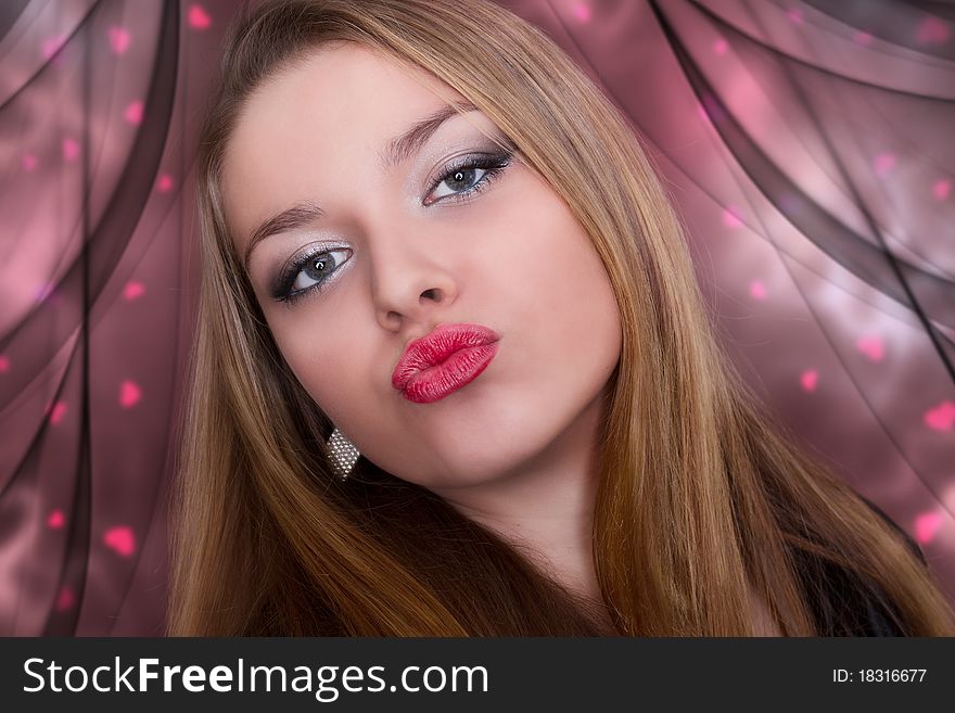 Kiss of a beautiful young woman. Valentine.