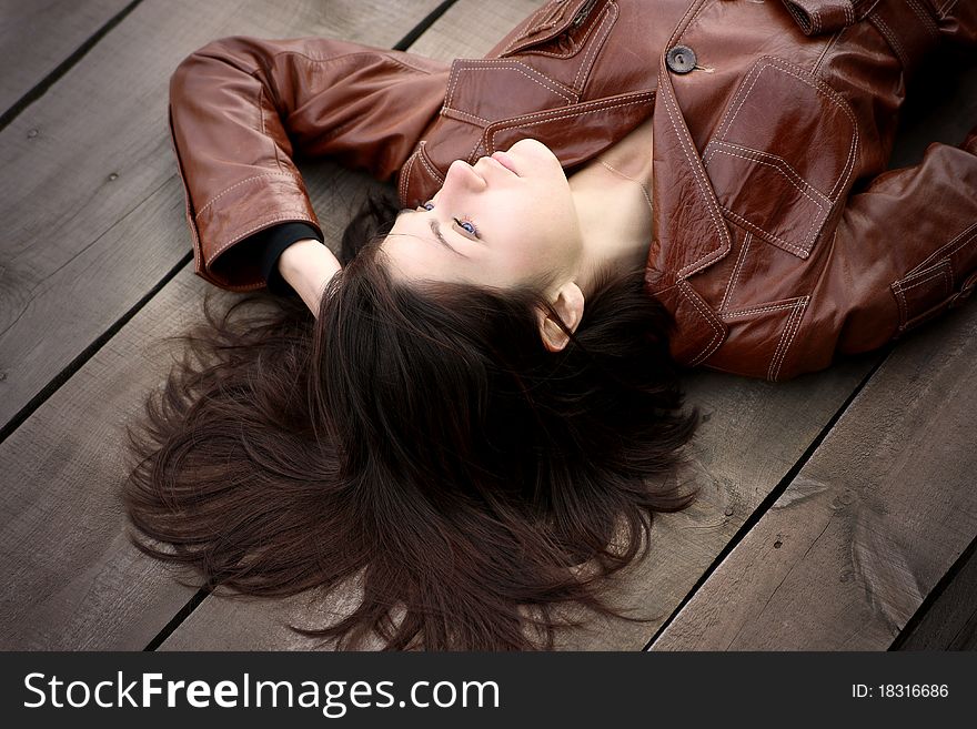 A beautiful young girl is in a brown jacket. A beautiful young girl is in a brown jacket