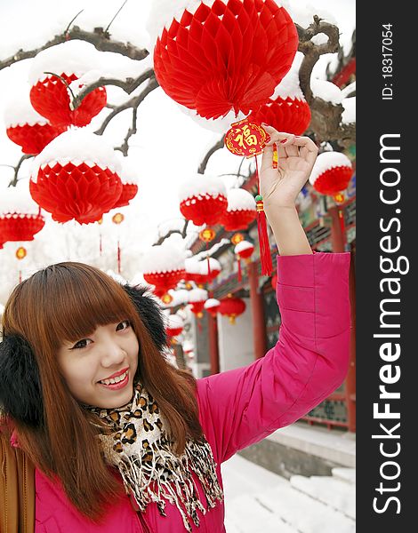 After New Year's first snow,it symbolizes good luck. Beautiful Chinese girl enjoying red lantern and Chinese knot in Chinese new year.(Close-up) Chinese characters on Chinese knot are Good Fortune and Get rich. After New Year's first snow,it symbolizes good luck. Beautiful Chinese girl enjoying red lantern and Chinese knot in Chinese new year.(Close-up) Chinese characters on Chinese knot are Good Fortune and Get rich