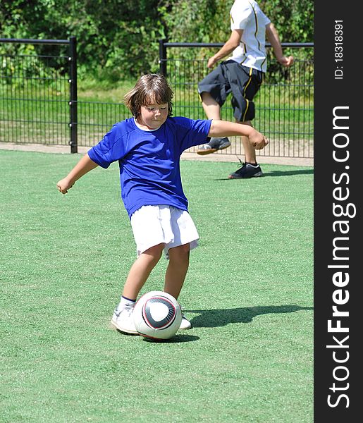 Young boy shooting ball