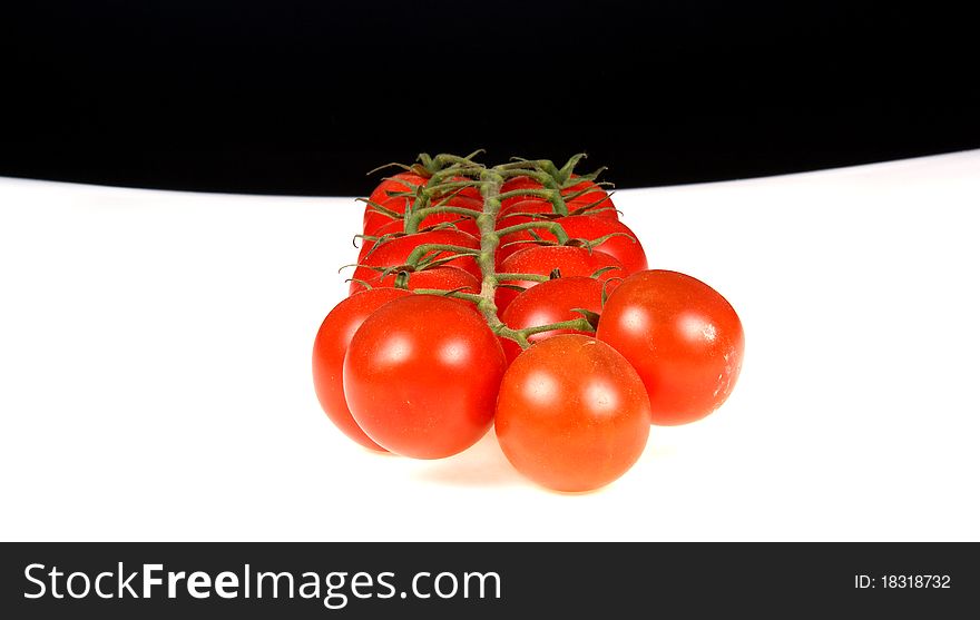 Cherry tomato --is a smaller garden variety of tomato, on a white and black background