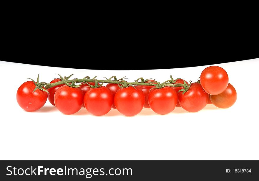 Cherry tomato --is a smaller garden variety of tomato, on a white and black background
