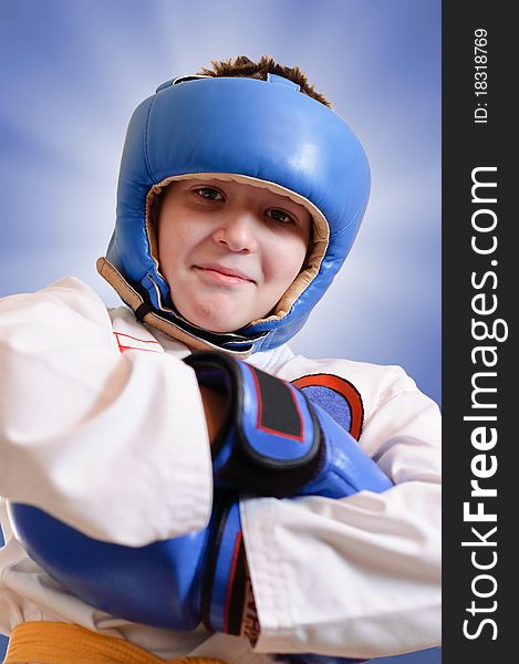 Young boxer on blue background