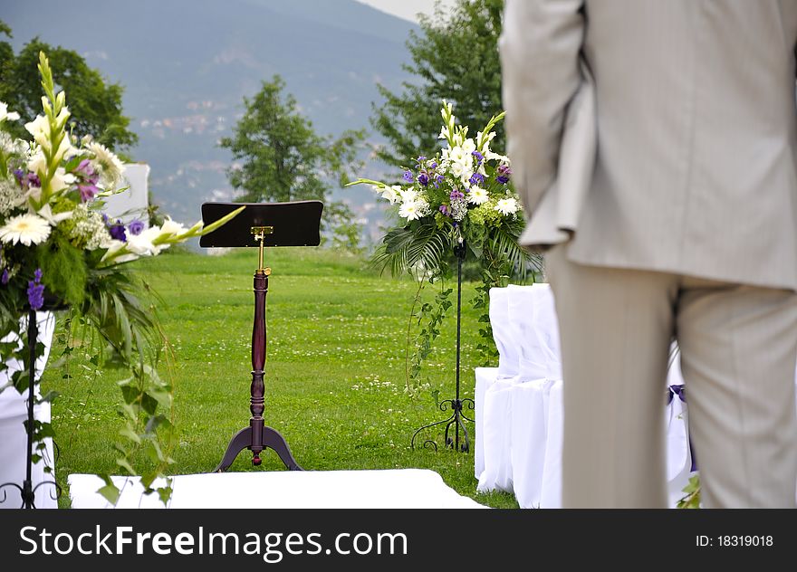 Man standing in front of wedding altar in nature