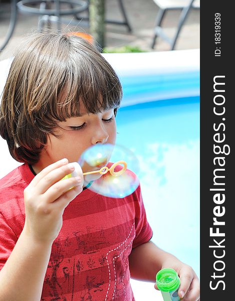 Little boy blowing bubbles