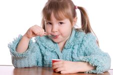 The Little Girl Eats Yoghurt Stock Photos The Little Girl Eats Yoghurt Stock Photos